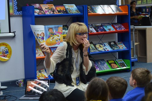 Author Julia Cook showing her new book to elementary students