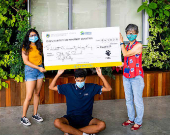 ISKL students and teachers holding a large cheque